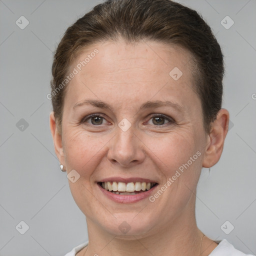 Joyful white adult female with short  brown hair and brown eyes