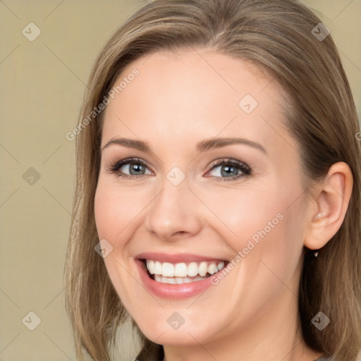 Joyful white young-adult female with long  brown hair and blue eyes