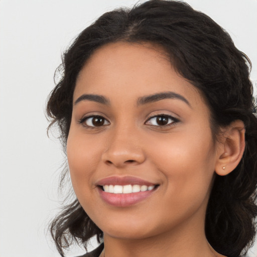 Joyful latino young-adult female with long  brown hair and brown eyes