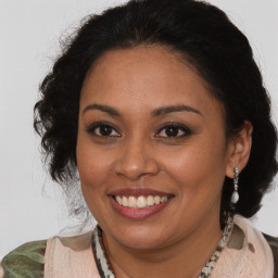 Joyful black young-adult female with medium  brown hair and brown eyes