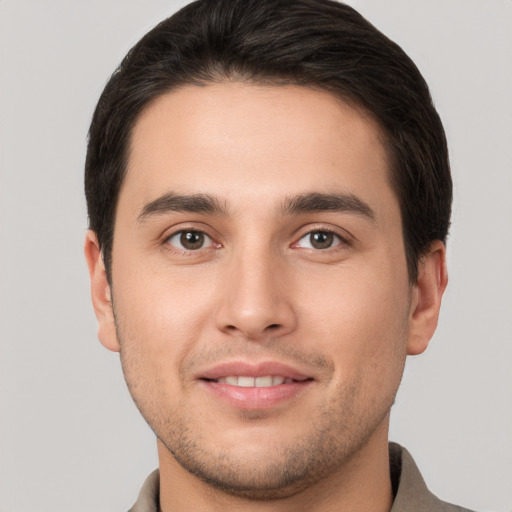 Joyful white young-adult male with short  brown hair and brown eyes