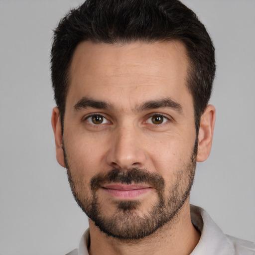 Joyful white adult male with short  brown hair and brown eyes