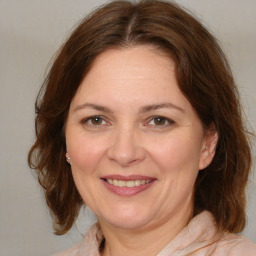 Joyful white adult female with medium  brown hair and brown eyes