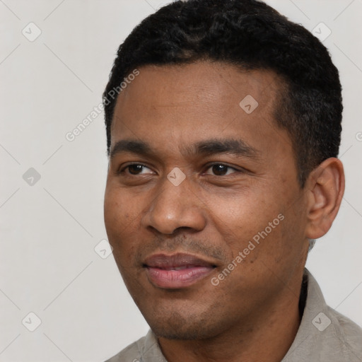 Joyful latino young-adult male with short  black hair and brown eyes