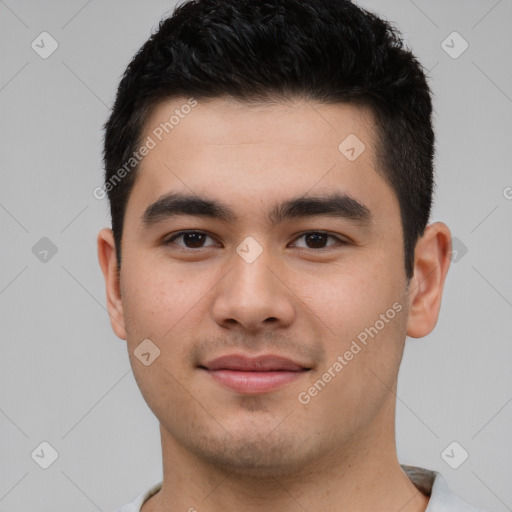 Joyful latino young-adult male with short  brown hair and brown eyes