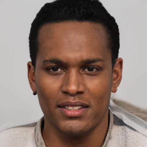 Joyful black young-adult male with short  black hair and brown eyes