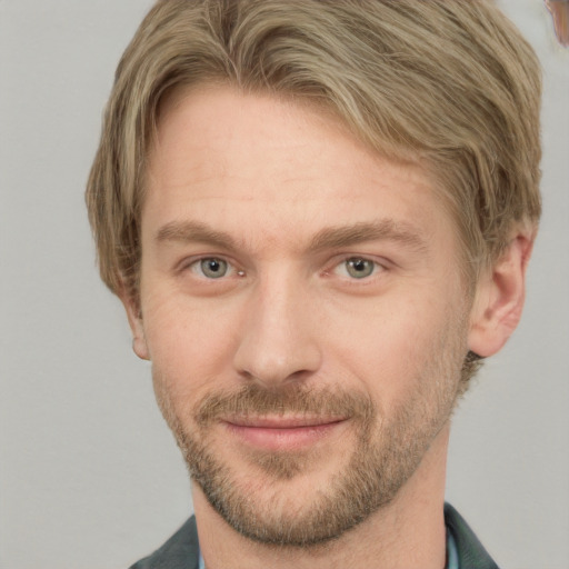 Joyful white adult male with short  brown hair and grey eyes