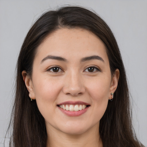 Joyful white young-adult female with long  brown hair and brown eyes