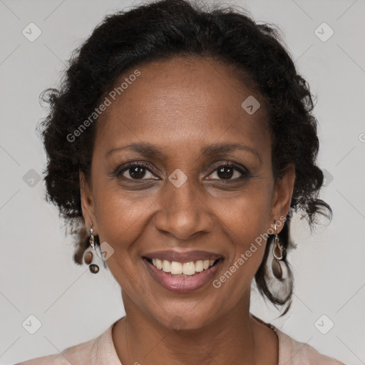 Joyful black adult female with medium  brown hair and brown eyes