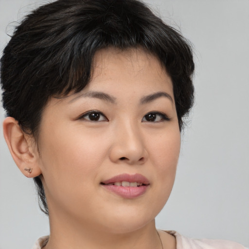 Joyful asian young-adult female with short  brown hair and brown eyes