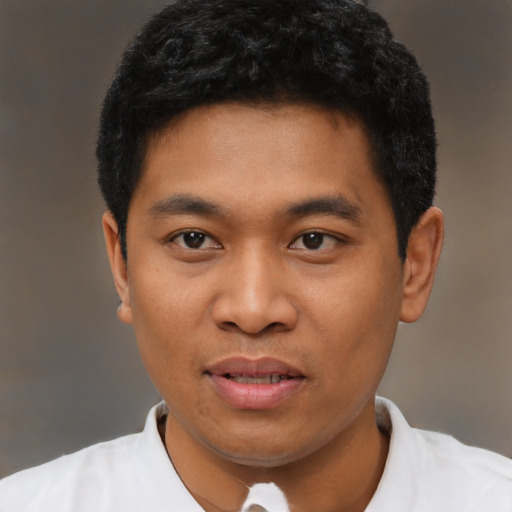 Joyful asian young-adult male with short  black hair and brown eyes