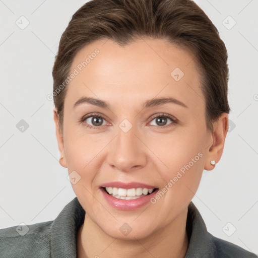 Joyful white young-adult female with short  brown hair and brown eyes