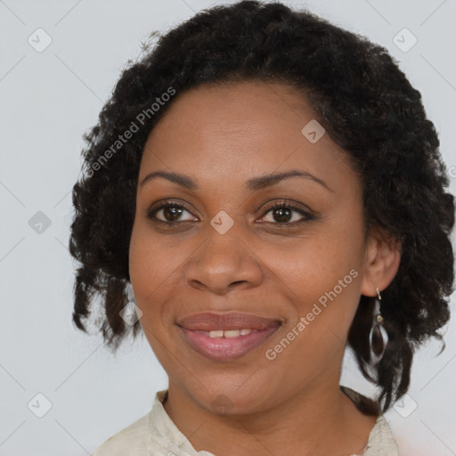 Joyful black adult female with medium  brown hair and brown eyes