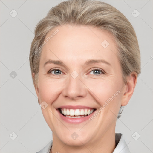 Joyful white adult female with short  brown hair and grey eyes