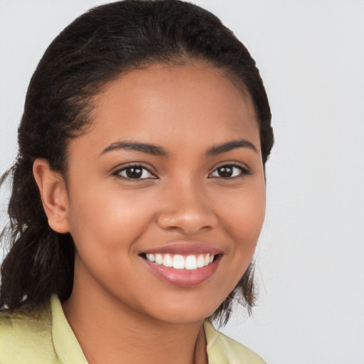 Joyful latino young-adult female with long  brown hair and brown eyes