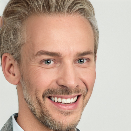 Joyful white adult male with short  brown hair and blue eyes