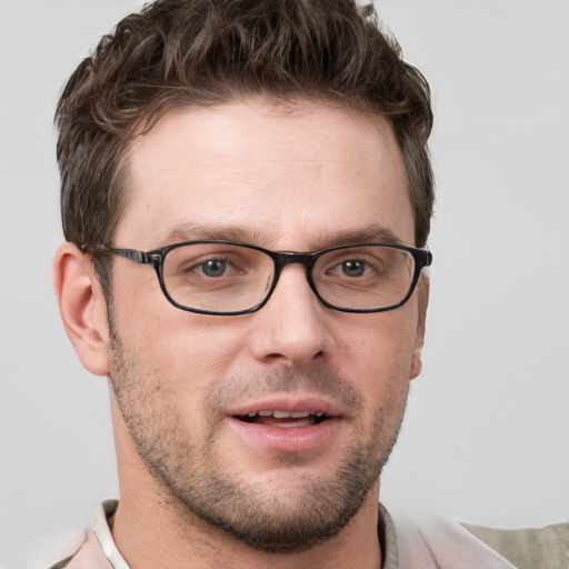 Joyful white young-adult male with short  brown hair and grey eyes