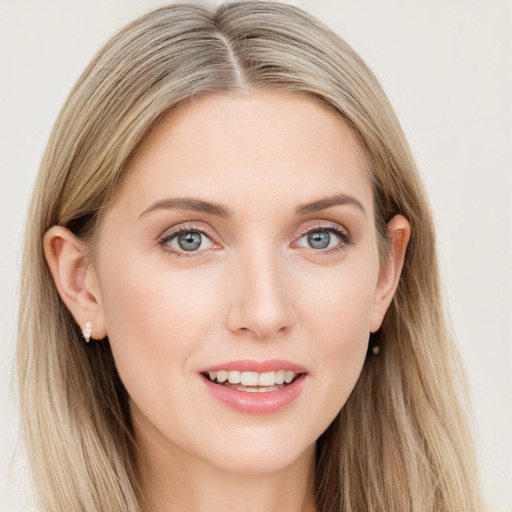 Joyful white young-adult female with long  brown hair and blue eyes