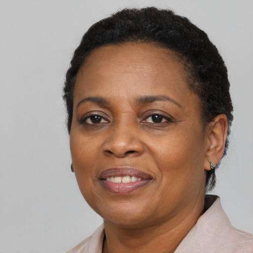 Joyful black adult female with short  black hair and brown eyes