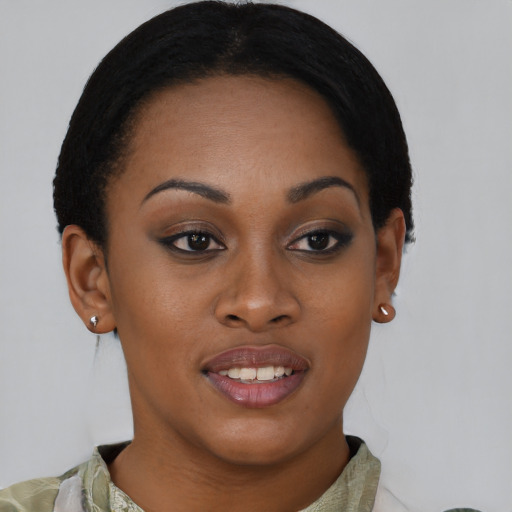 Joyful black young-adult female with short  brown hair and brown eyes