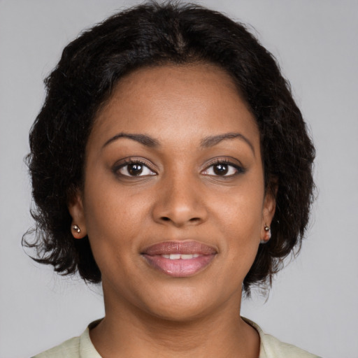 Joyful black young-adult female with medium  brown hair and brown eyes