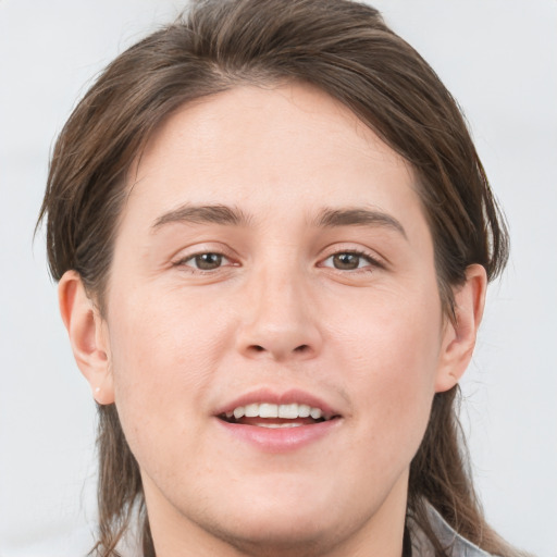 Joyful white young-adult male with medium  brown hair and grey eyes