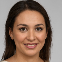 Joyful white young-adult female with medium  brown hair and brown eyes