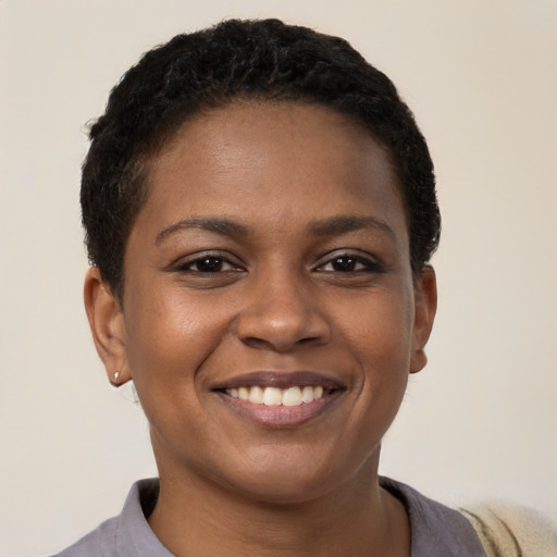 Joyful black young-adult female with short  brown hair and brown eyes