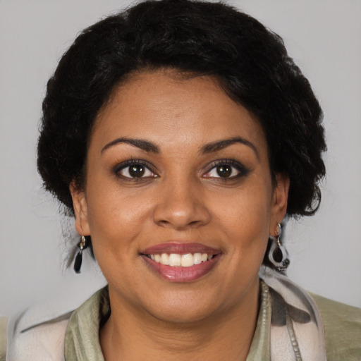 Joyful black young-adult female with medium  brown hair and brown eyes