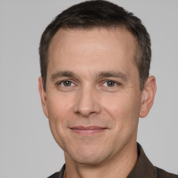 Joyful white adult male with short  brown hair and brown eyes