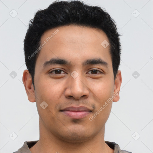 Joyful latino young-adult male with short  black hair and brown eyes