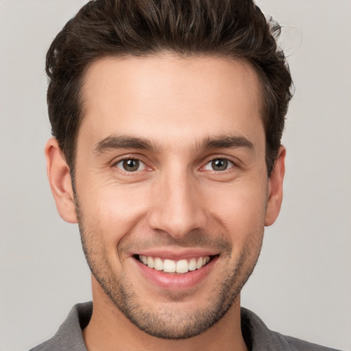 Joyful white young-adult male with short  brown hair and brown eyes