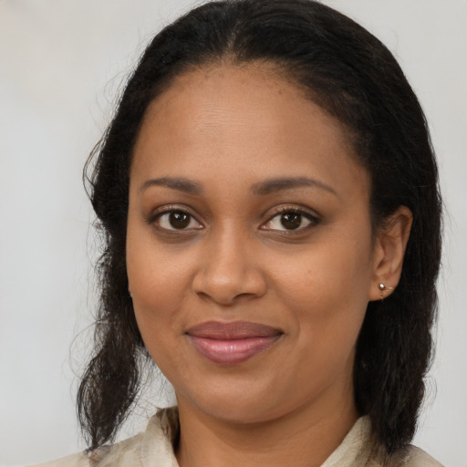 Joyful black young-adult female with medium  brown hair and brown eyes