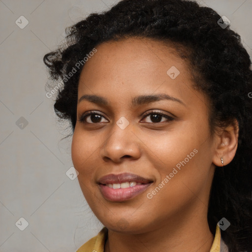 Joyful black young-adult female with long  black hair and brown eyes