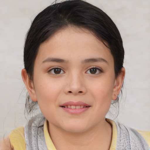 Joyful asian child female with short  brown hair and brown eyes