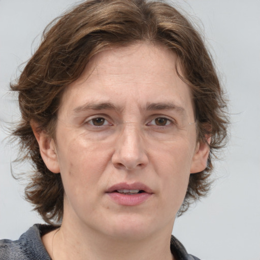 Joyful white adult female with medium  brown hair and grey eyes