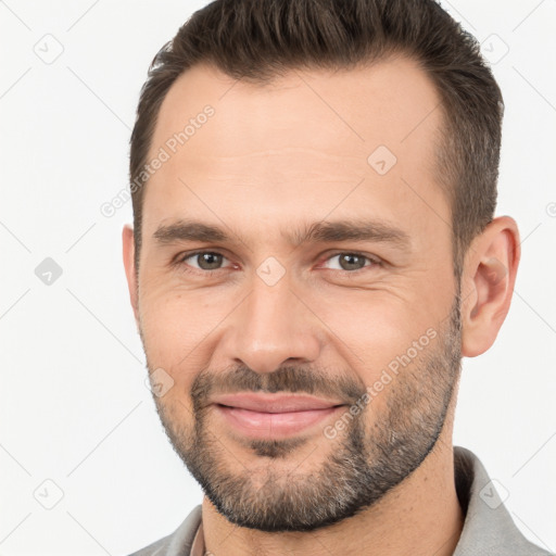 Joyful white adult male with short  brown hair and brown eyes