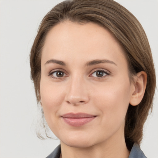 Joyful white young-adult female with medium  brown hair and grey eyes