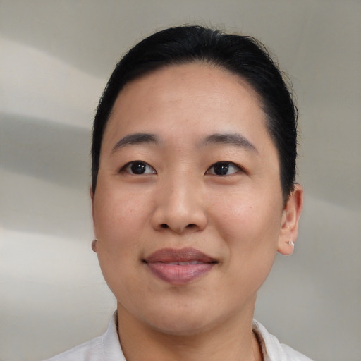 Joyful asian young-adult female with short  brown hair and brown eyes