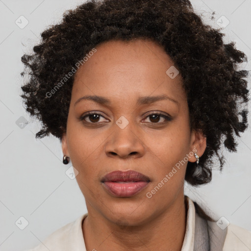 Joyful black adult female with short  brown hair and brown eyes