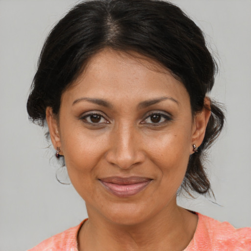 Joyful black adult female with medium  brown hair and brown eyes