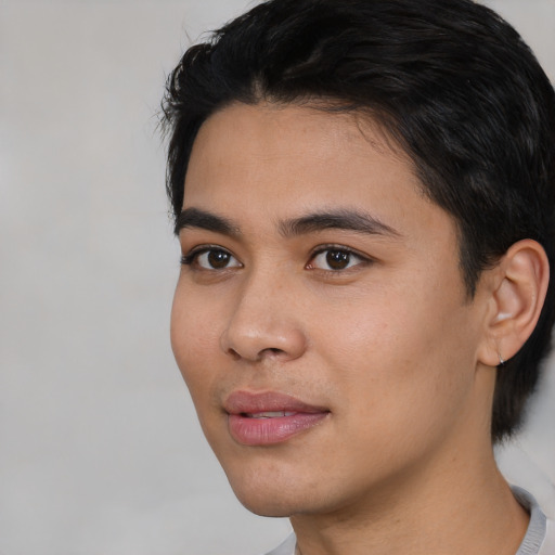 Joyful asian young-adult male with short  black hair and brown eyes