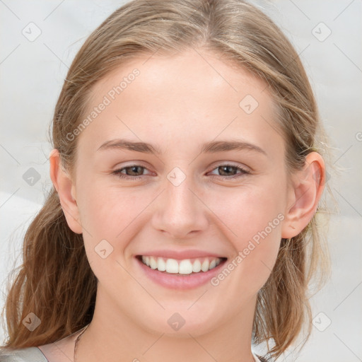 Joyful white young-adult female with medium  brown hair and blue eyes