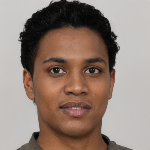 Joyful black young-adult male with short  black hair and brown eyes