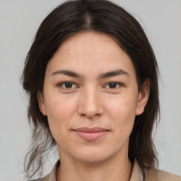 Joyful white young-adult female with medium  brown hair and brown eyes