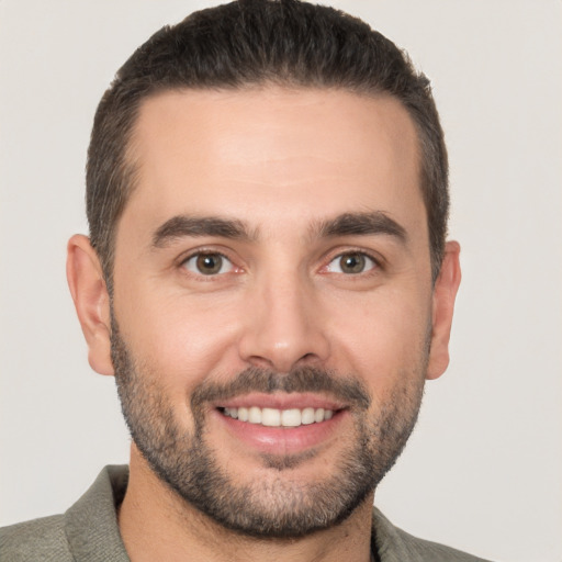 Joyful white young-adult male with short  brown hair and brown eyes