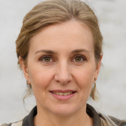 Joyful white adult female with medium  brown hair and grey eyes