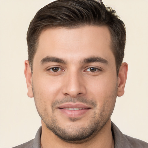 Joyful white young-adult male with short  brown hair and brown eyes