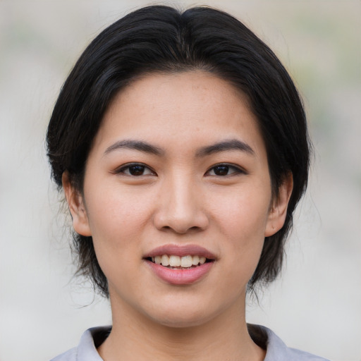 Joyful asian young-adult female with medium  black hair and brown eyes