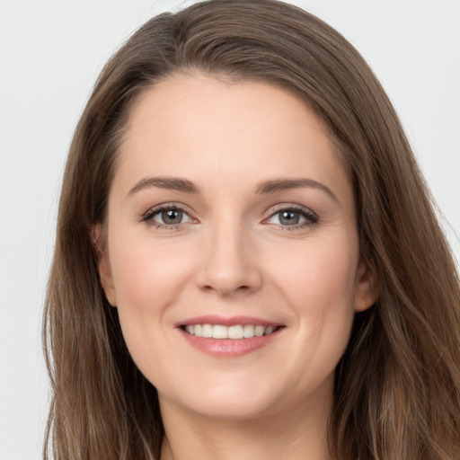 Joyful white young-adult female with long  brown hair and grey eyes